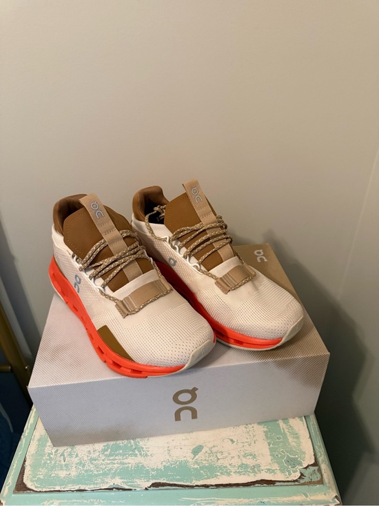 On Running Shoes - On Running women’s  Cloudnova Cream with Tan Upper and Orange Sole